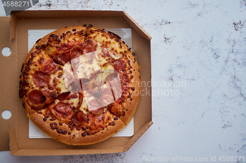 Image of Delicious pepperoni pizza in the in delivery box