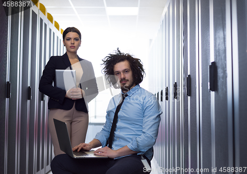 Image of Team of young technicians working together on servers