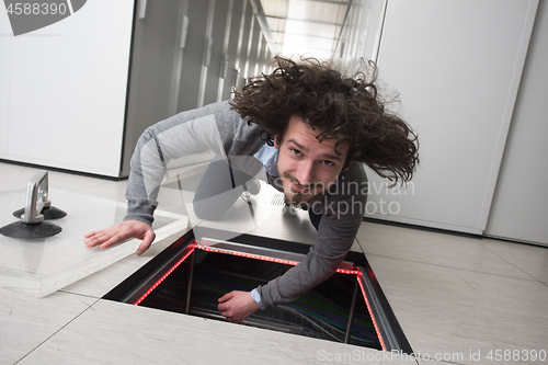 Image of engineer connecting cables in server room