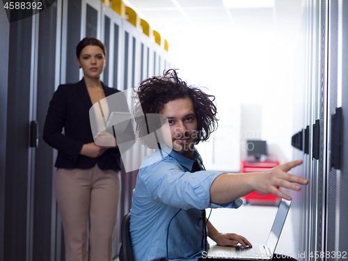 Image of Team of young technicians working together on servers