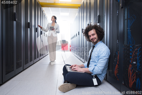 Image of Team of young technicians working together on servers