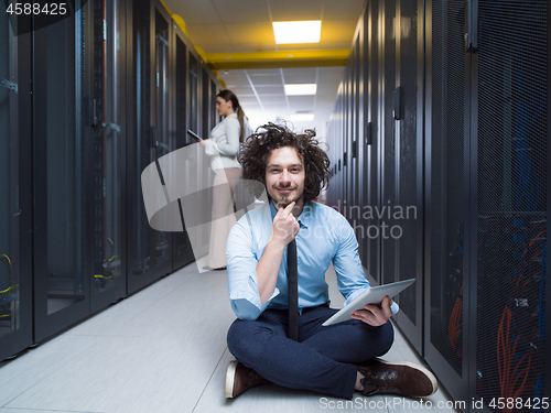 Image of young technicians working together on servers