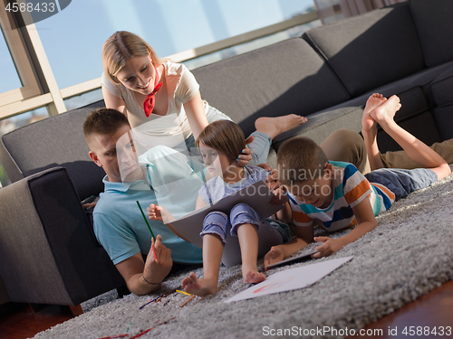 Image of young happy couple spending time with kids