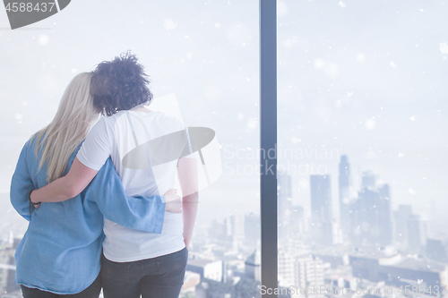 Image of young couple enjoying morning coffee by the window