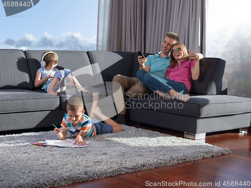 Image of young happy couple spending time with kids