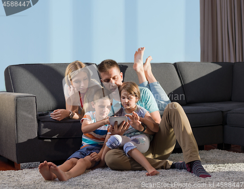 Image of happy young couple spending time with kids