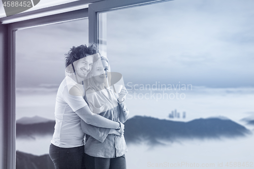 Image of young couple enjoying morning coffee by the window