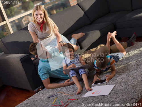 Image of young happy couple spending time with kids