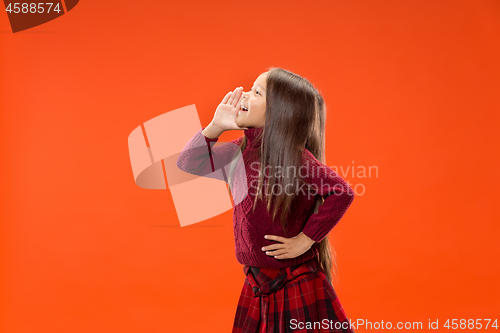 Image of Isolated on blue young casual teen girl shouting at studio