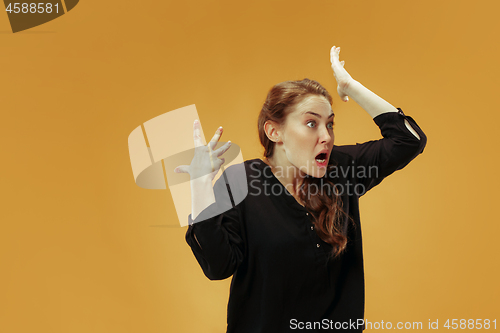 Image of Beautiful female half-length portrait isolated on studio backgroud. The young emotional surprised woman