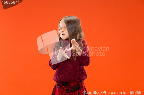 Image of Portrait of angry teen girl on studio background