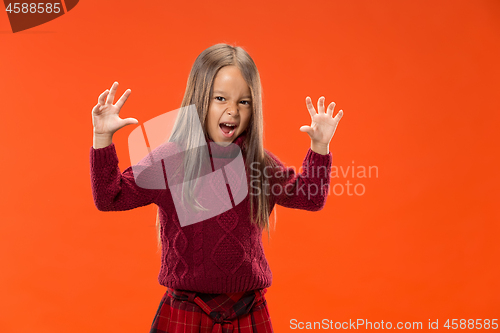 Image of Portrait of angry teen girl on studio background