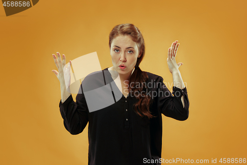 Image of Beautiful female half-length portrait isolated on studio backgroud. The young emotional surprised woman