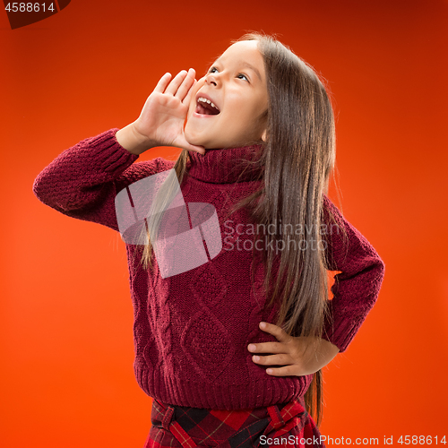 Image of Isolated on blue young casual teen girl shouting at studio