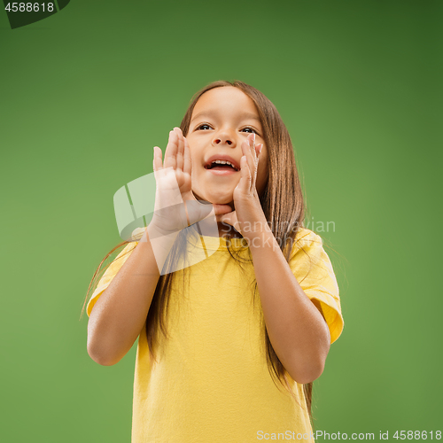 Image of Isolated on blue young casual teen girl shouting at studio