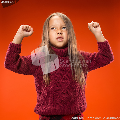 Image of Portrait of angry teen girl on studio background