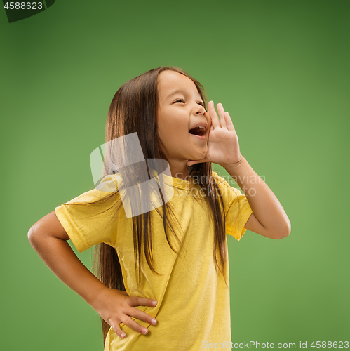 Image of Isolated on blue young casual teen girl shouting at studio