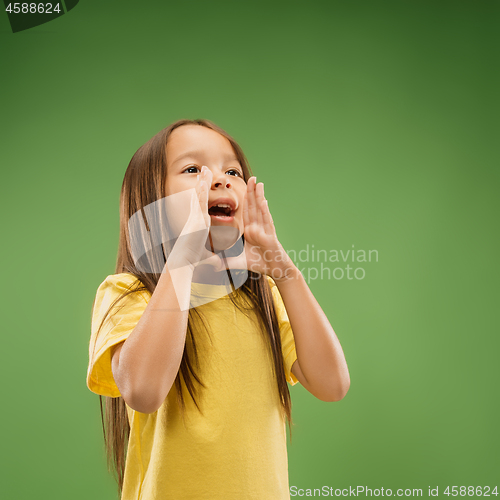 Image of Isolated on blue young casual teen girl shouting at studio