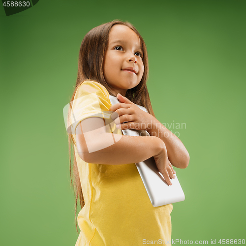 Image of Teen girl with laptop. Love to computer concept. Attractive female half-length front portrait, trendy green studio backgroud.