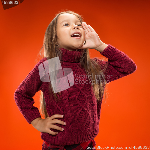 Image of Isolated on blue young casual teen girl shouting at studio