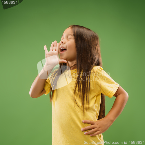 Image of Isolated on blue young casual teen girl shouting at studio