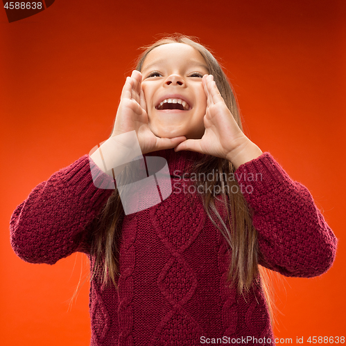 Image of Isolated on blue young casual teen girl shouting at studio