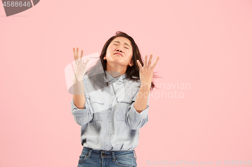 Image of Beautiful woman looking suprised and bewildered isolated on pink