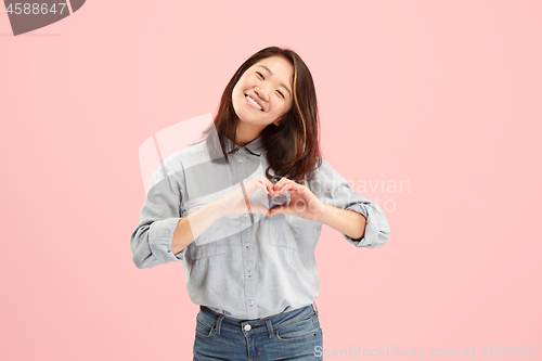 Image of Portrait of attractive cute girl with bright makeup with kiss isolated over pink background