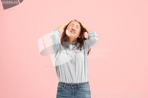 Image of Beautiful woman looking suprised and bewildered isolated on pink