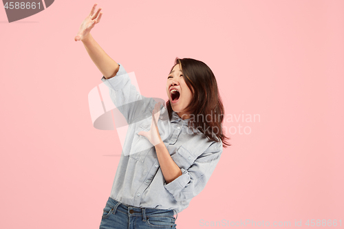 Image of Portrait of the scared woman on pink