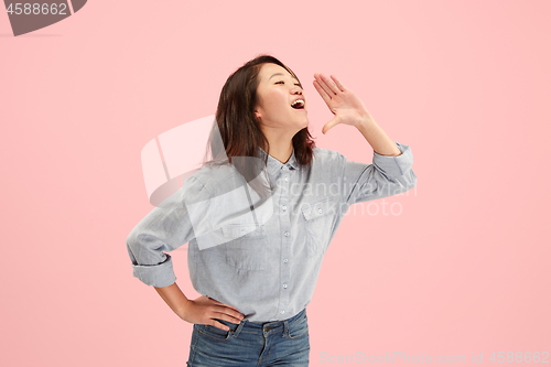 Image of Isolated on pink young casual woman shouting at studio