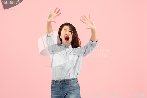 Image of Portrait of the scared woman on pink