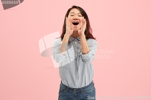 Image of Isolated on pink young casual woman shouting at studio