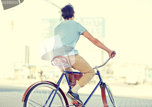 Image of hipster man riding fixed gear bike