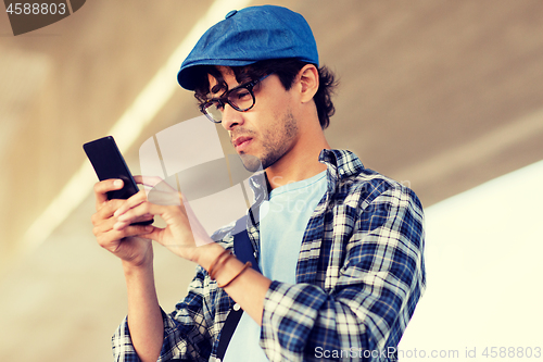 Image of hipster man texting message on smartphone