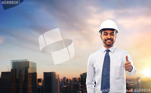 Image of architect or businessman in helmet shows thumbs up