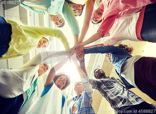 Image of group of international students with hands on top