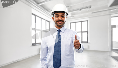 Image of architect or businessman in helmet shows thumbs up