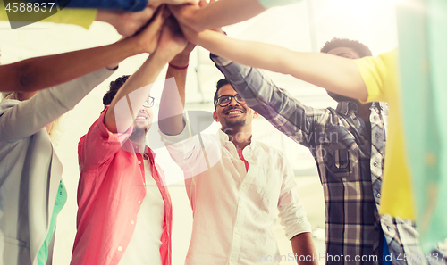 Image of group of international students making high five