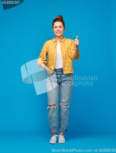 Image of happy red haired teenage girl showing thumbs up