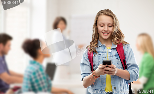 Image of teen student girl with school bag and smartphone