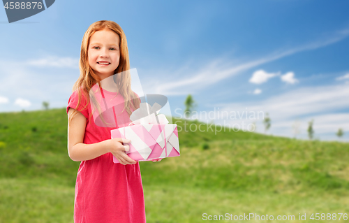 Image of smiling red haired girl with birthday gift