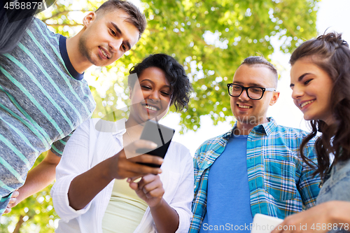 Image of happy friends with smartphones at summer park