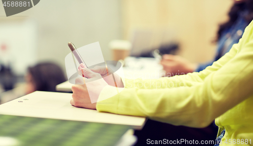 Image of close up of student with smartphones on lecture