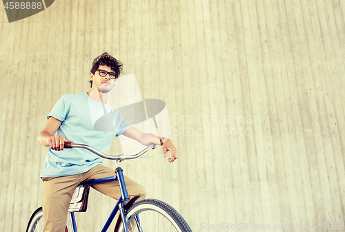 Image of young hipster man riding fixed gear bike