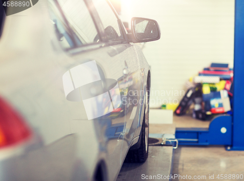 Image of car on lift at repair station