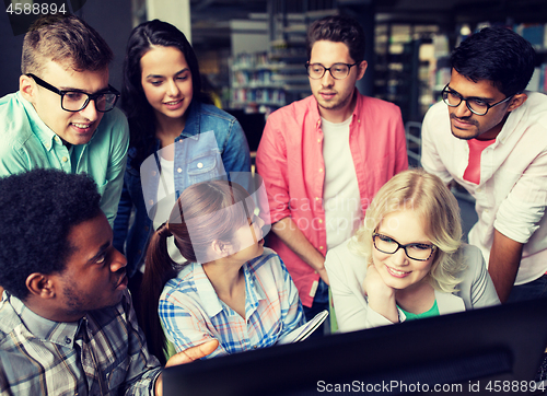 Image of international students with computers at library