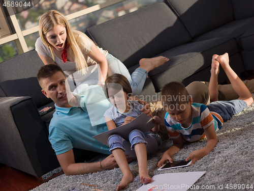 Image of young happy couple spending time with kids