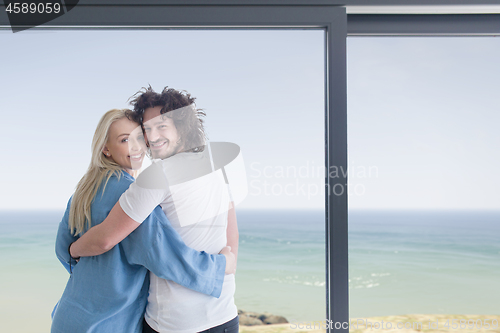 Image of young couple enjoying morning coffee by the window