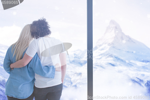 Image of young couple enjoying morning coffee by the window